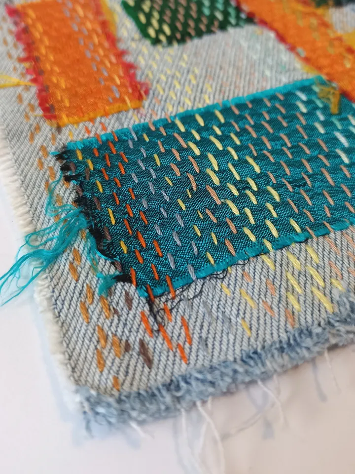 Upcycled denim boro patch – visible mending.