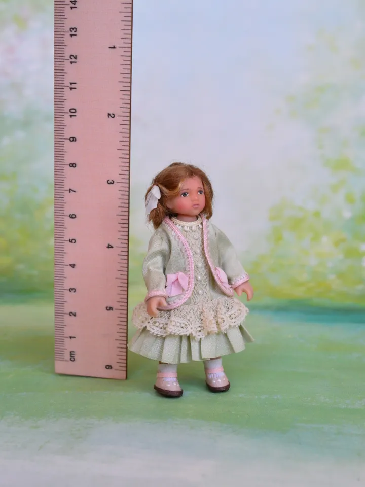 Miniature girl doll for Victorian dollhouse in 1/12 scale.