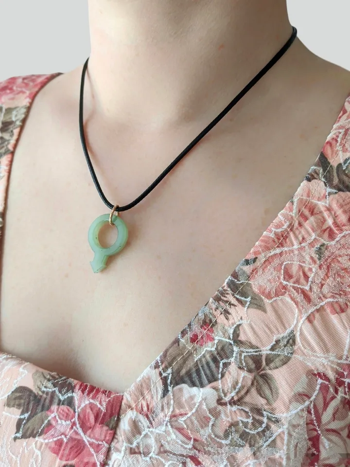 Green jade pendant gender male sign symbol of Mars LGBTQ.
