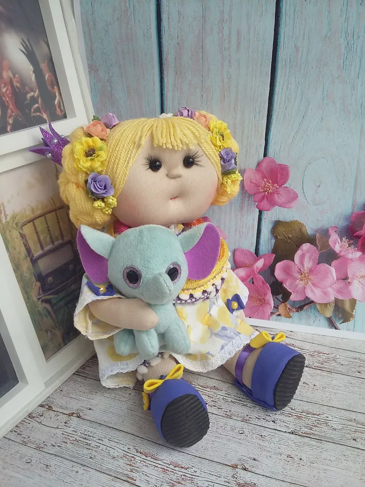 Doll Princess in the crown with an elephant in her hands, with yellow hair, beautiful, interior, birthday present, holiday