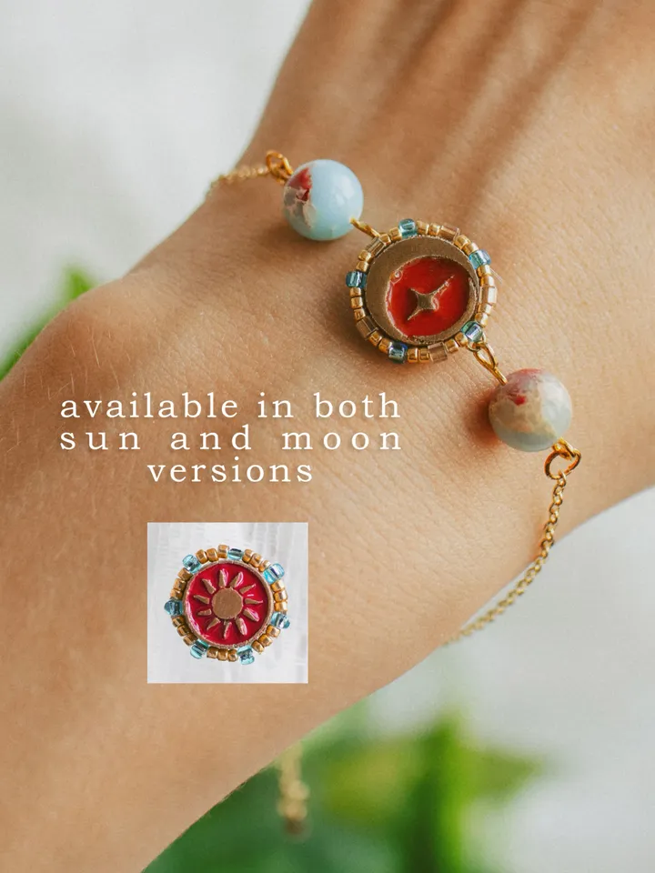 Charm bracelet When The Sun Meets The Moon with blue jasper. Gold stackable jewelry ith celestial design in sunset red and orange color with beading. Adjustable length. Maylina Soul