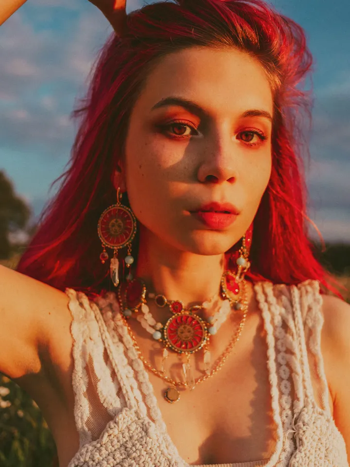 Statement necklace When The Sun Meets The Moon with blue jasper and clear quartz crystals. Gold jewelry with celestial design in sunset red and orange color with beading. Maylina Soul