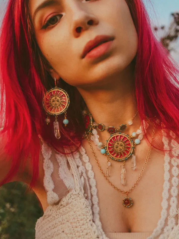 Pendant necklace When The Sun Meets The Moon with blue jasper and clear quartz crystals. Gold jewelry with celestial design in sunset red and orange color with beading. Maylina Soul