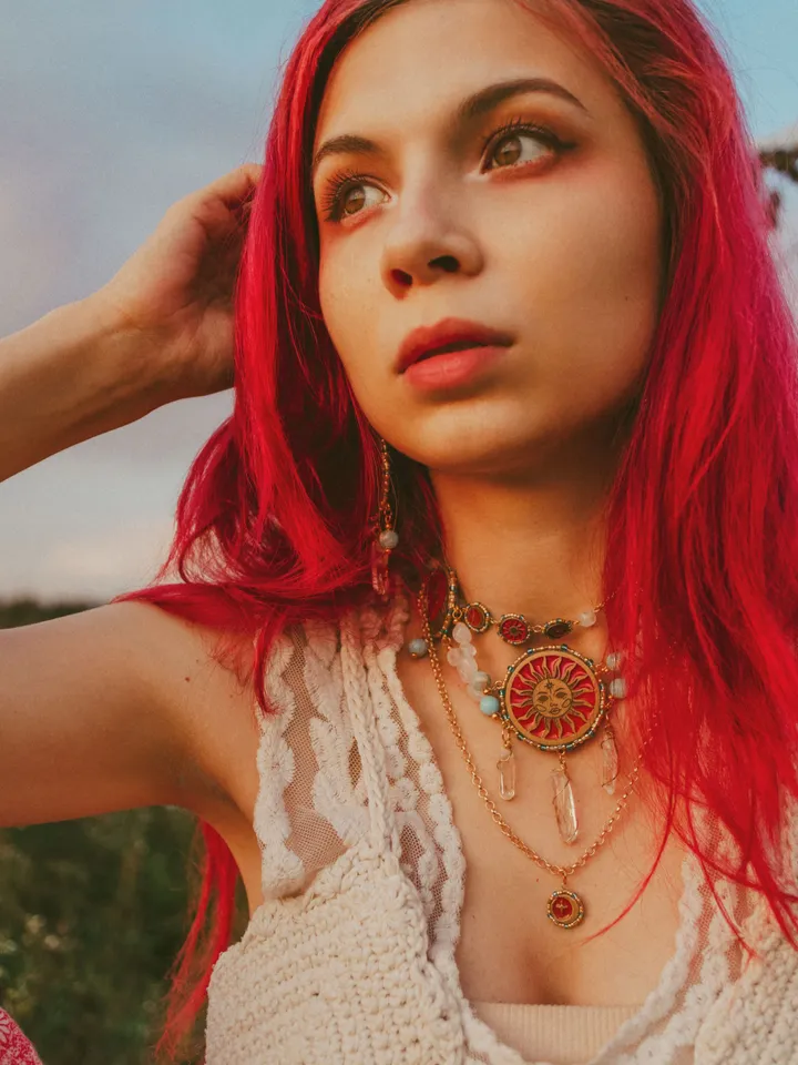 Statement necklace When The Sun Meets The Moon with blue jasper and clear quartz crystals. Gold jewelry with celestial design in sunset red and orange color with beading. Maylina Soul
