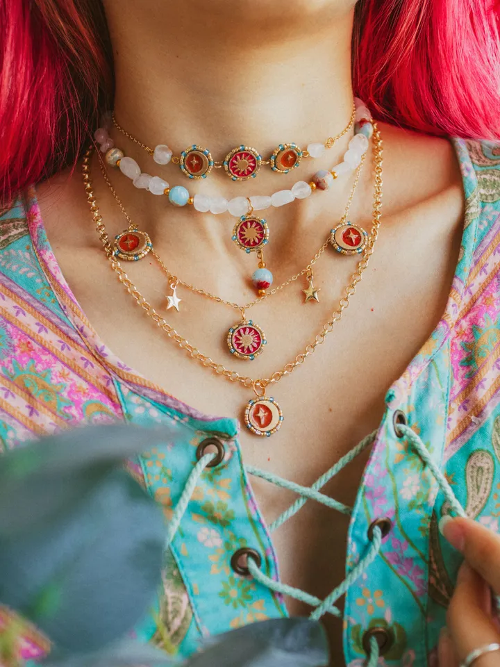 Small pendant necklace When The Sun Meets The Moon. Gold stackable jewelry with celestial design in sunset red or orange color with beading. Maylina Soul