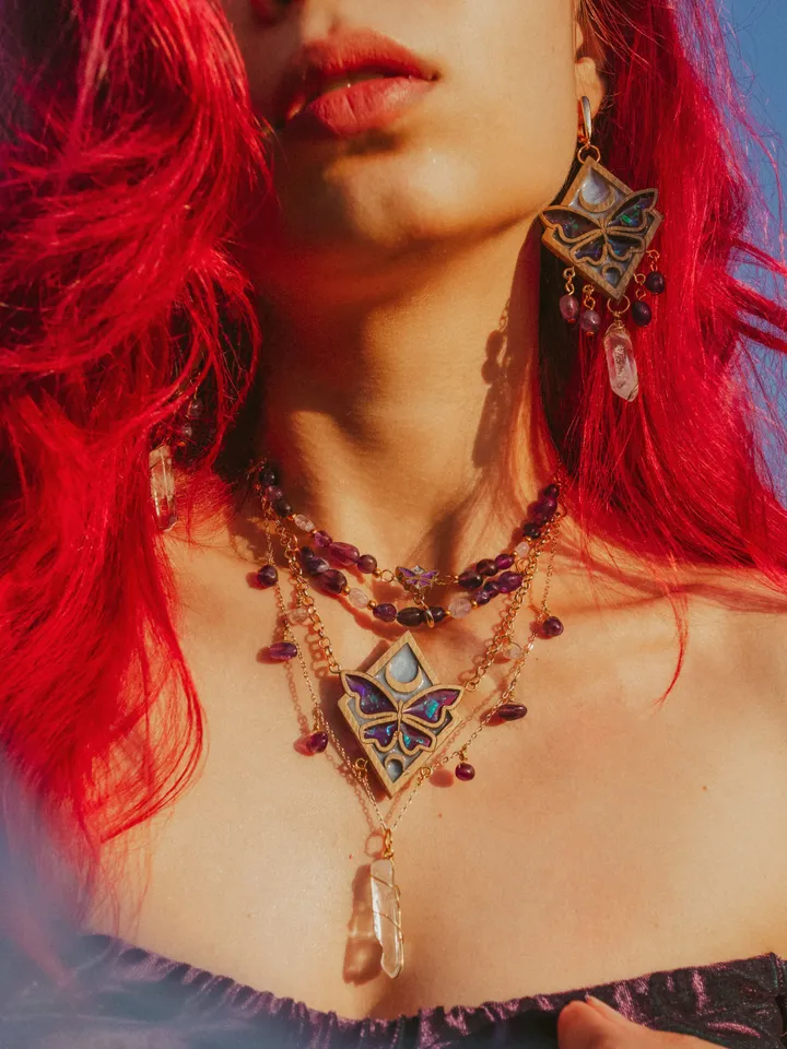 Pendant necklace Moonlight Serenity with amethyst and clear quartz crystals. Gold jewelry with butterflies and moons in light blue and deep purple color and iridescent shine. Maylina Soul