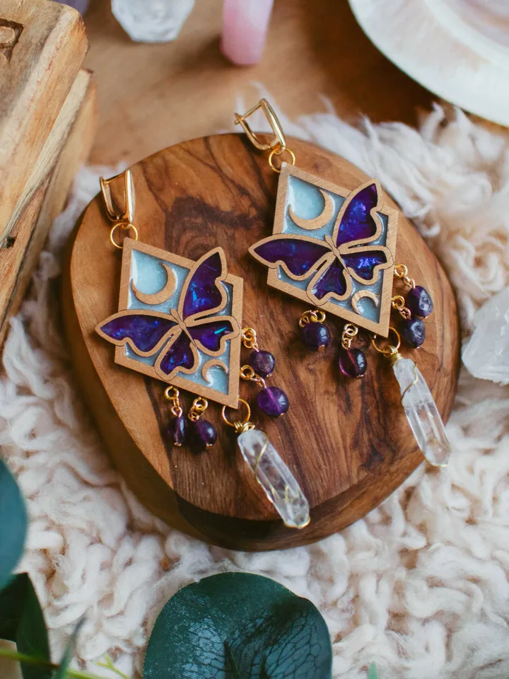 Big statement earrings Moonlight Serenity with amethyst and clear quartz crystals. Gold jewelry with butterflies and moons in light blue and deep purple color and iridescent shine. Maylina Soul