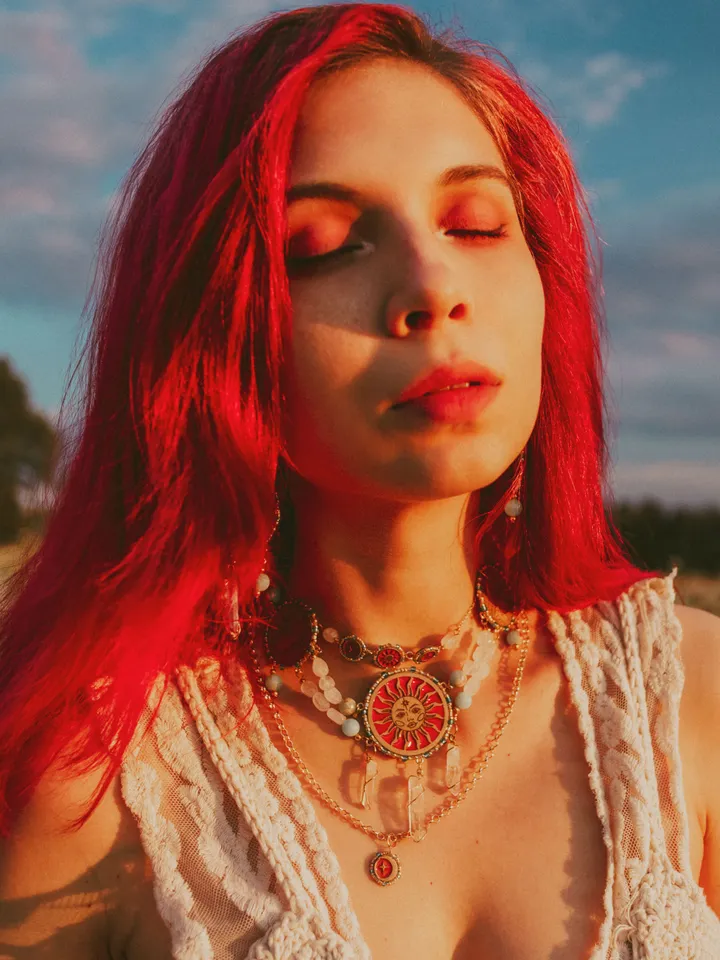 Statement necklace When The Sun Meets The Moon with blue jasper and clear quartz crystals. Gold jewelry with celestial design in sunset red and orange color with beading. Maylina Soul
