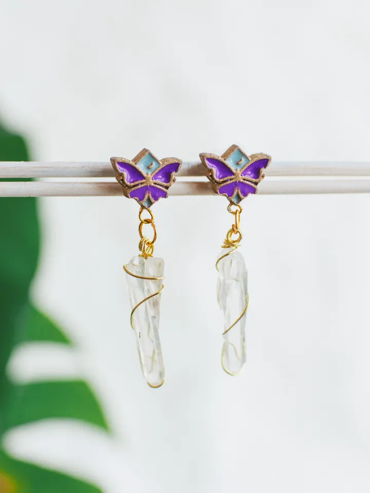 Stud earrings Moonlight Serenity with clear quartz crystals. Gold jewelry with butterflies and moons in light blue and deep purple color. Maylina Soul
