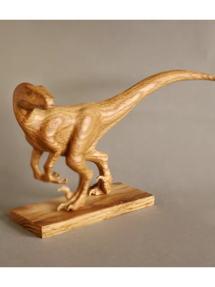 Wooden hand carved dinosaur velociraptor