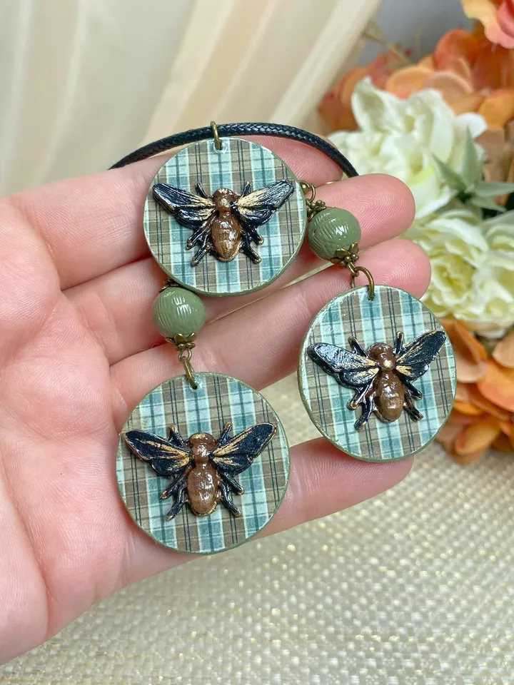 Author's set of handmade jewelry.Earrings and pendant on a cord with voluminous flies.