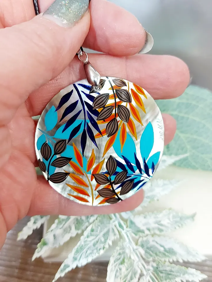 Artistic Expression in Nacre: Abstract Botanical Hand-Painted Mother-of-Pearl Pendant - Captivating Blue and Orange Leaf Motif
