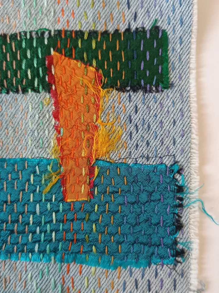 Upcycled denim boro patch – visible mending.