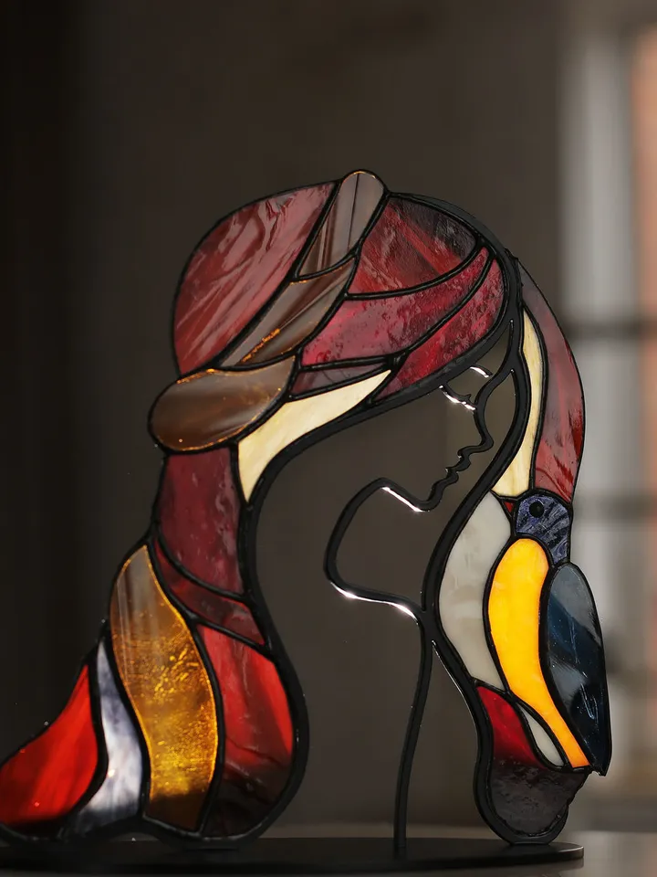 Girl with a Bird. Tiffany Stained Glass, Stained Glass Featuring a Girl and a Bird, Stained Glass with a Girl and Bird on a Stand, Stained Glass "Girl and Bird" on Base, Stained Glass Featuring a Girl and Bird