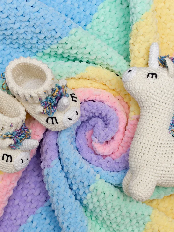 Pregnancy gift basket with crochet unicorn booties sweet toy and rainbow striped multicolored blanket Bright newborn new mom parents gift
