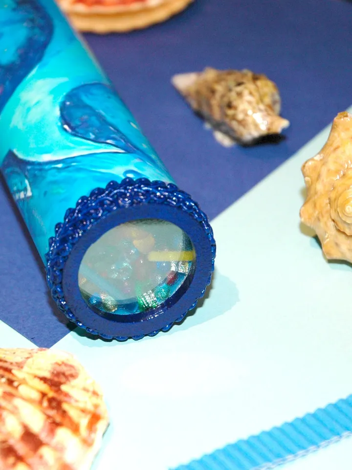 Glass kaleidoscope with Blue whale painting on label. Unusual gift for men who have everything