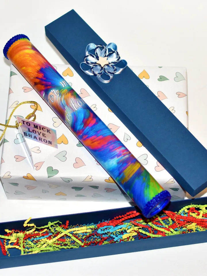 Glass kaleidoscope with modern rainbow print on label. Relaxing gifts.