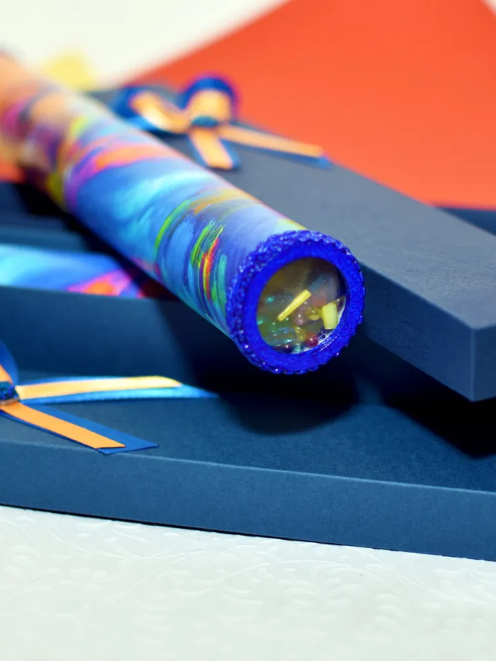 Glass kaleidoscope with modern rainbow print on label. Relaxing gifts.