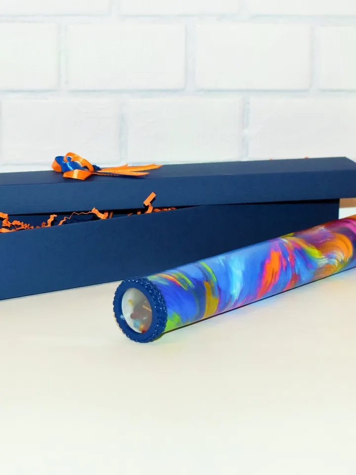 Glass kaleidoscope with modern rainbow print on label. Relaxing gifts.