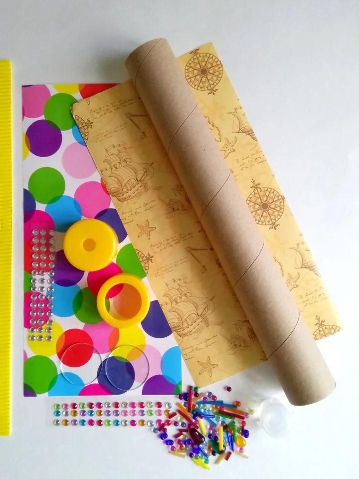 Mystery box with DIY kaleidoscope kit. Educational activity and toddler learning toy. Christmas eve box with stim toy and adult craft kit.