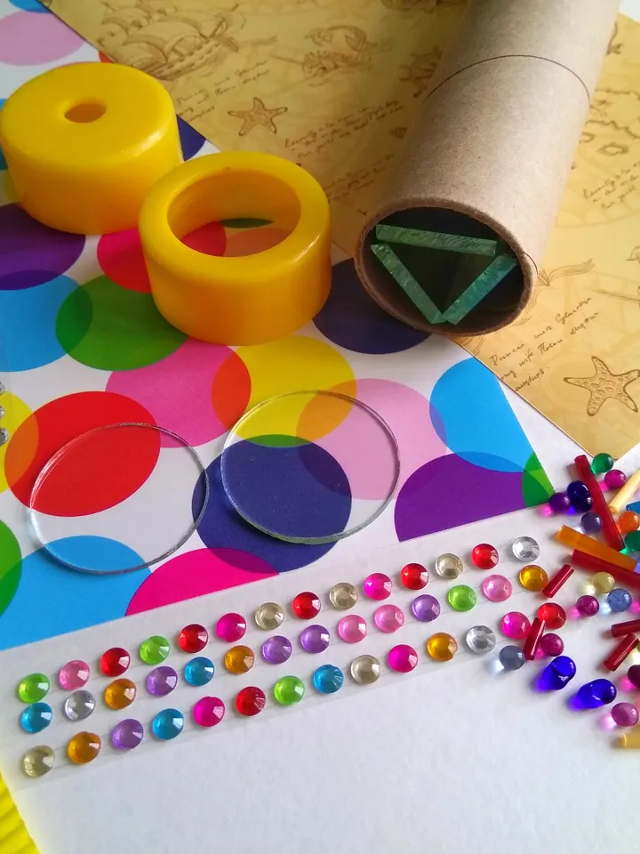 Mystery box with DIY kaleidoscope kit. Educational activity and toddler learning toy. Christmas eve box with stim toy and adult craft kit.