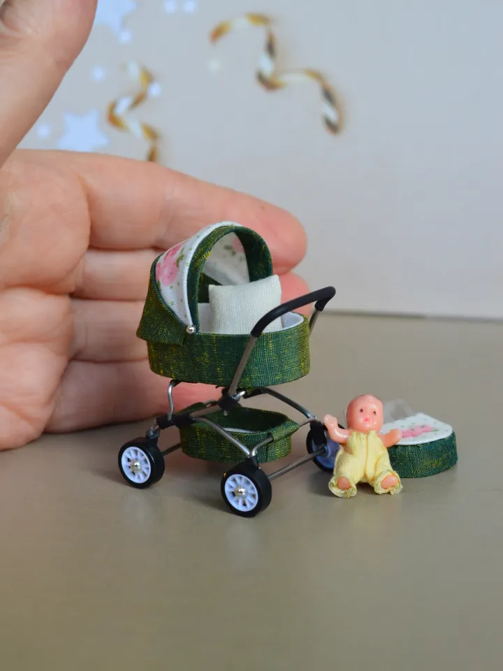 Miniature toy doll stroller in 1/24 scale. Complete with baby doll.