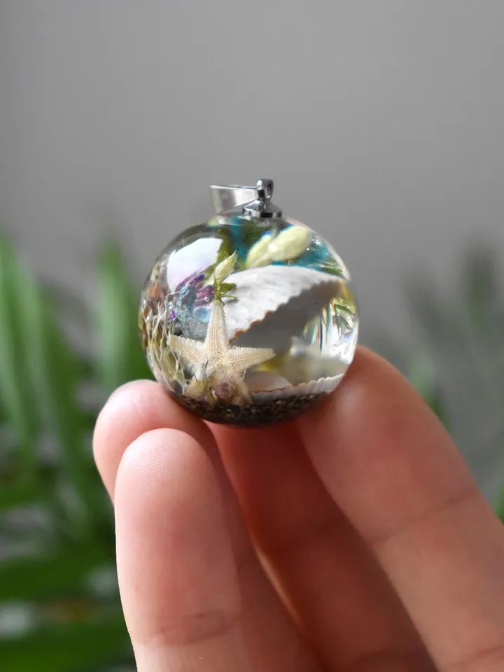 Shell with a pearl pendant. Sea pendant with shell, pearl and real flowers. Pinctada pendant.