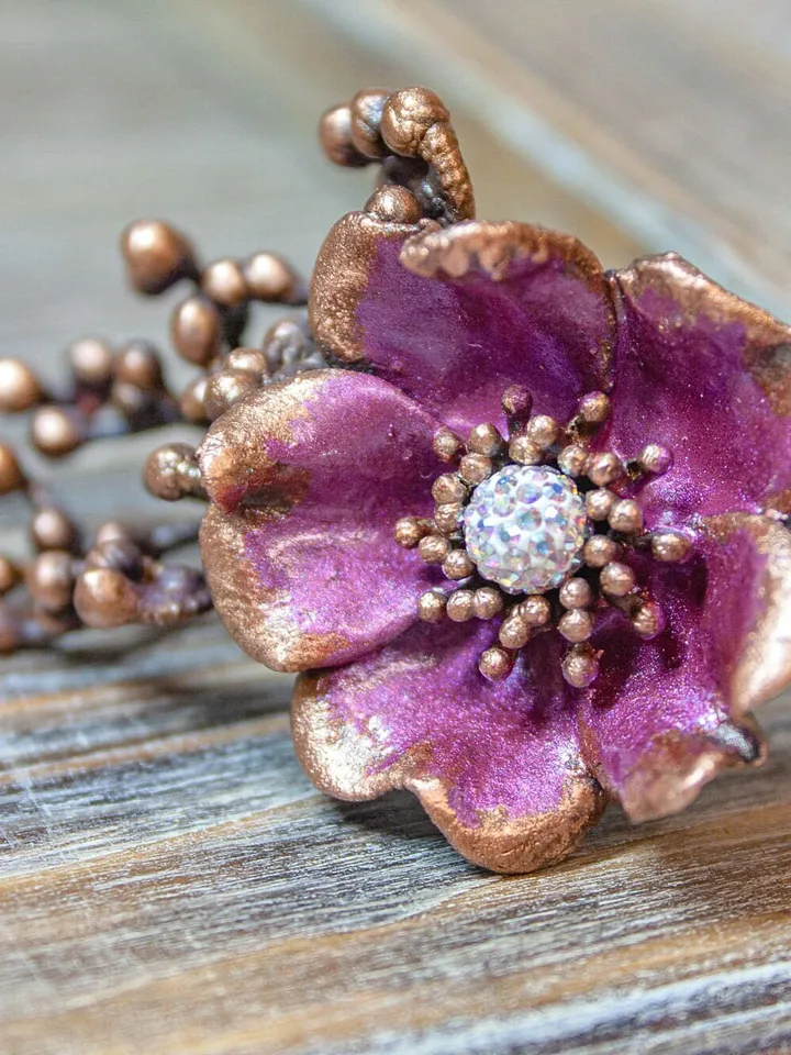 Unique handmade copper ring made from a real flower bud using the electroforming method, decorated with a Swarovski crystal
