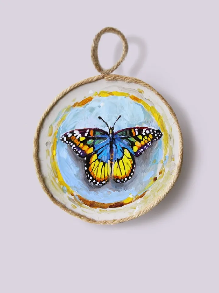 Butterfly medallions painted with oil paints on quartz vinyl, with a loop to hang. 3 pieces.