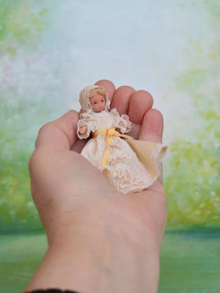 Miniature baby doll for Victorian dollhouse in 1/12 scale.