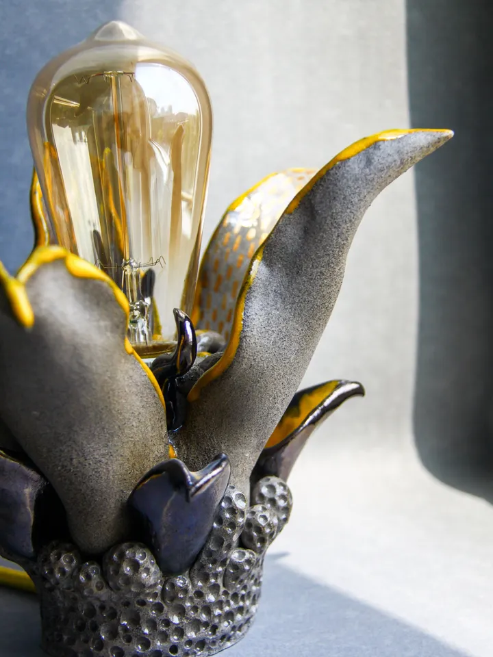 Altar table or witch starter kit can complement unique ceramic table lamp