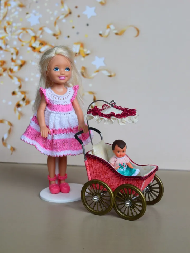 Miniature toy stroller for a little doll. Pram for the little poopsie.
