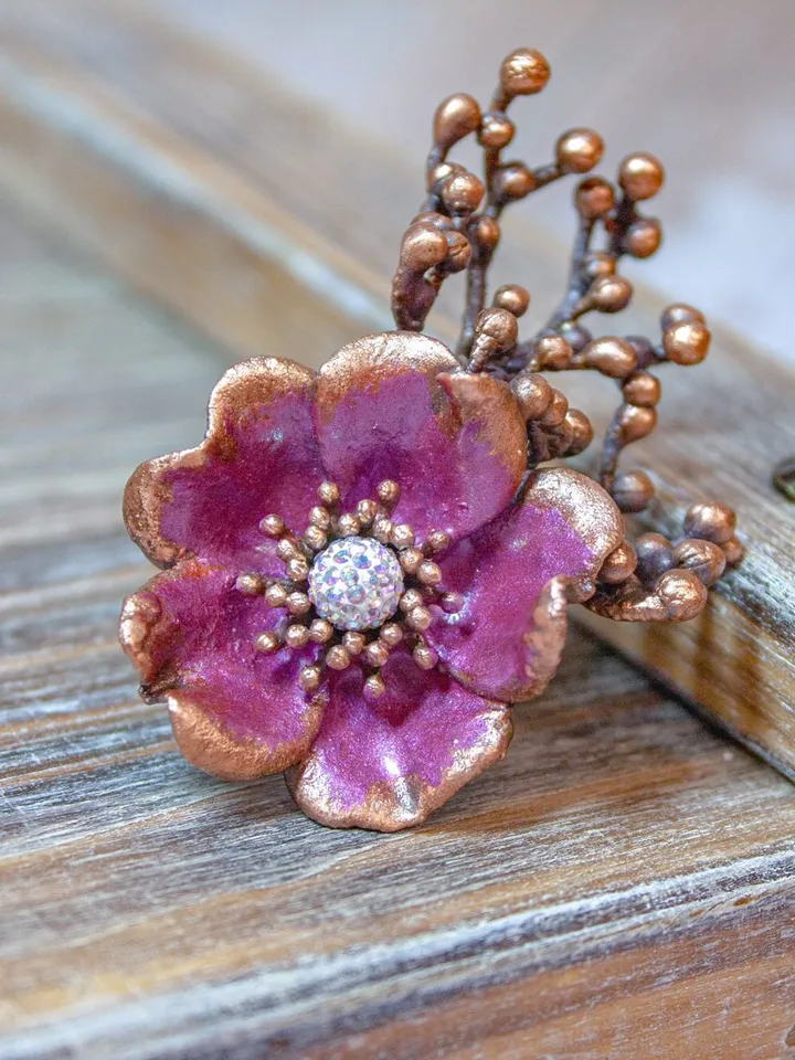 Unique handmade copper ring made from a real flower bud using the electroforming method, decorated with a Swarovski crystal