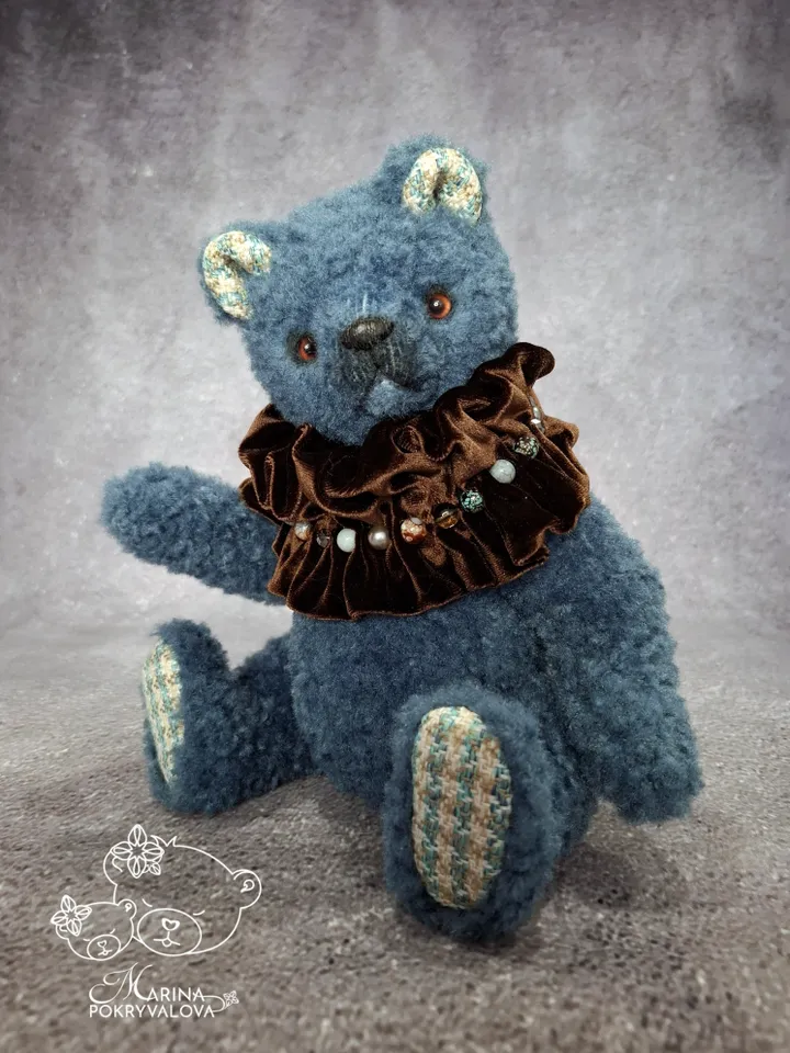 Blue teddy bear. Handmade toy. Plush bear.