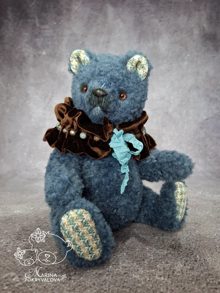 Blue teddy bear. Handmade toy. Plush bear.