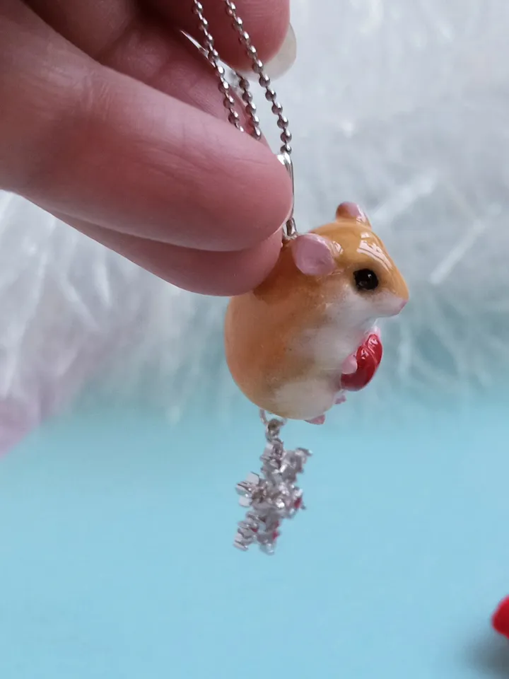A small handmade hamster necklace in red and white color