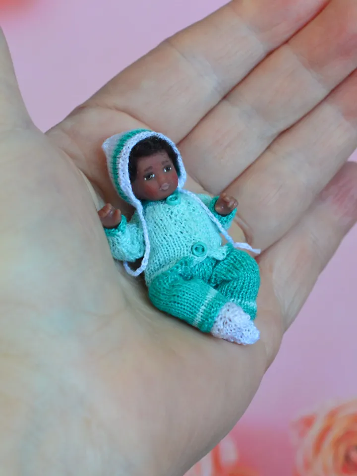 Miniature doll child in 12th scales. A baby for the dollhouse. Baby in a blue suit.