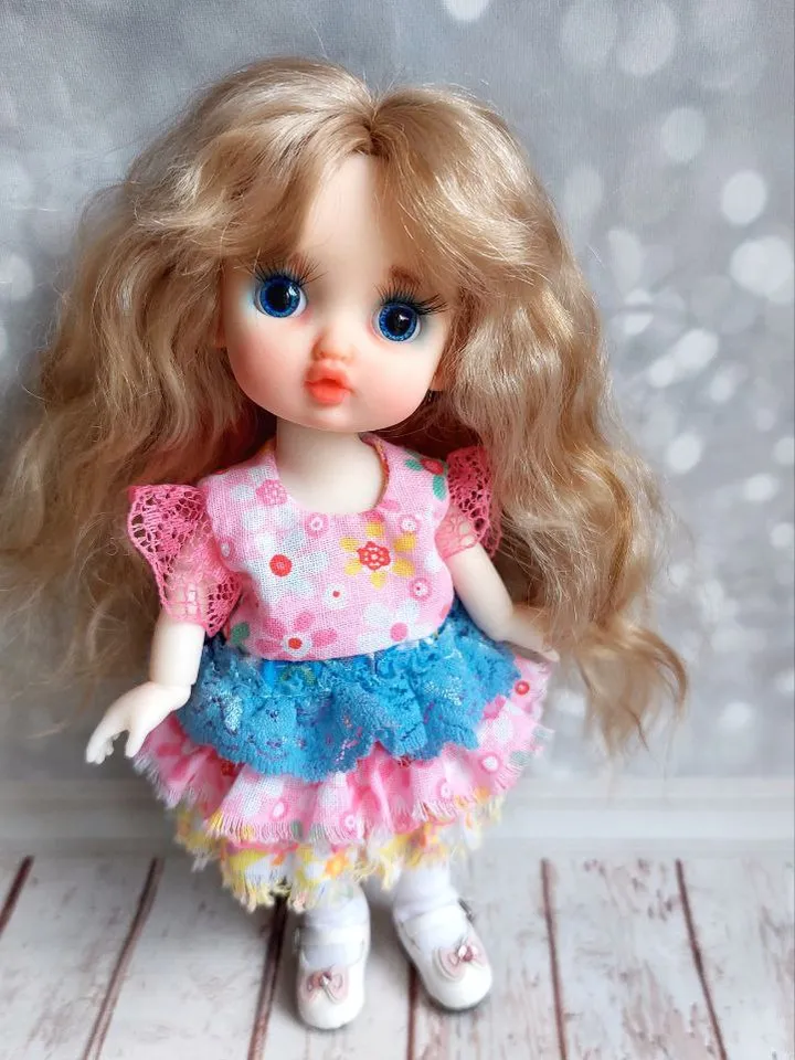 Blonde doll with blue eyes. Small doll on an articulated body.