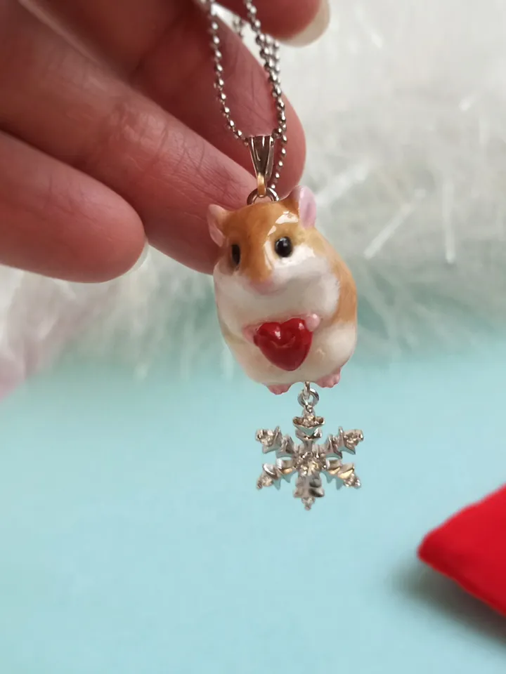 A small handmade hamster necklace in red and white color