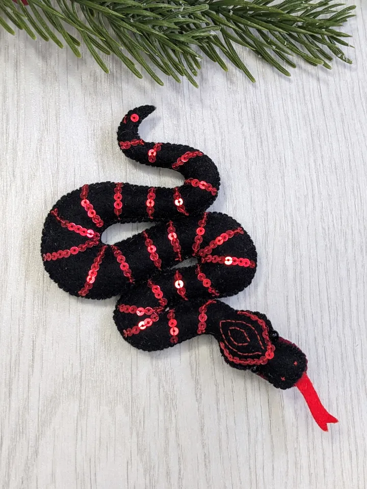 Sinaloyan snake, California king snake. Symbol of the New Year 2025 according to the eastern calendar, a black snake, a Christmas gift.