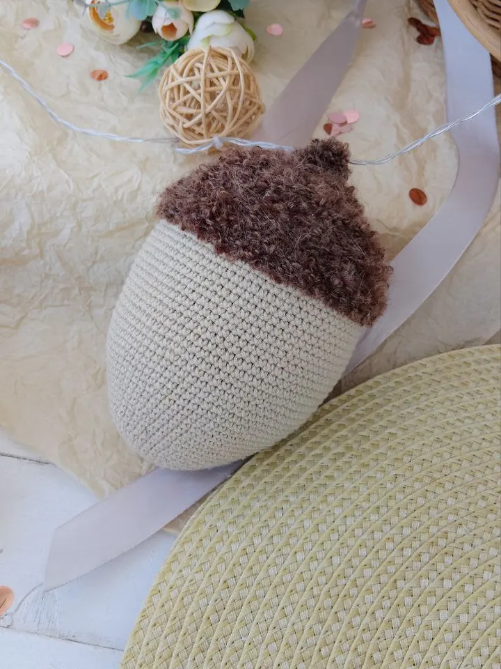 Stuffed biege acorn toy for Home decor. Acorn in Scandinavian style. Decoration of apartments and houses. Universal gift