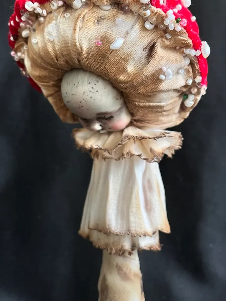 Art doll Mushroom. Unusual handmade statuette. Sleeping child-toy in the image of a fly mushroom. Mushroom is a textile sculpture. Unique statuette made of fabric and polymer clay, decorated with beads and beads. An art object for your interior and collec