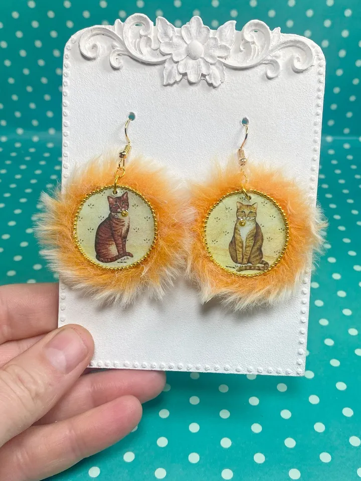 Cute handmade earrings. Image of cats, fur trim.