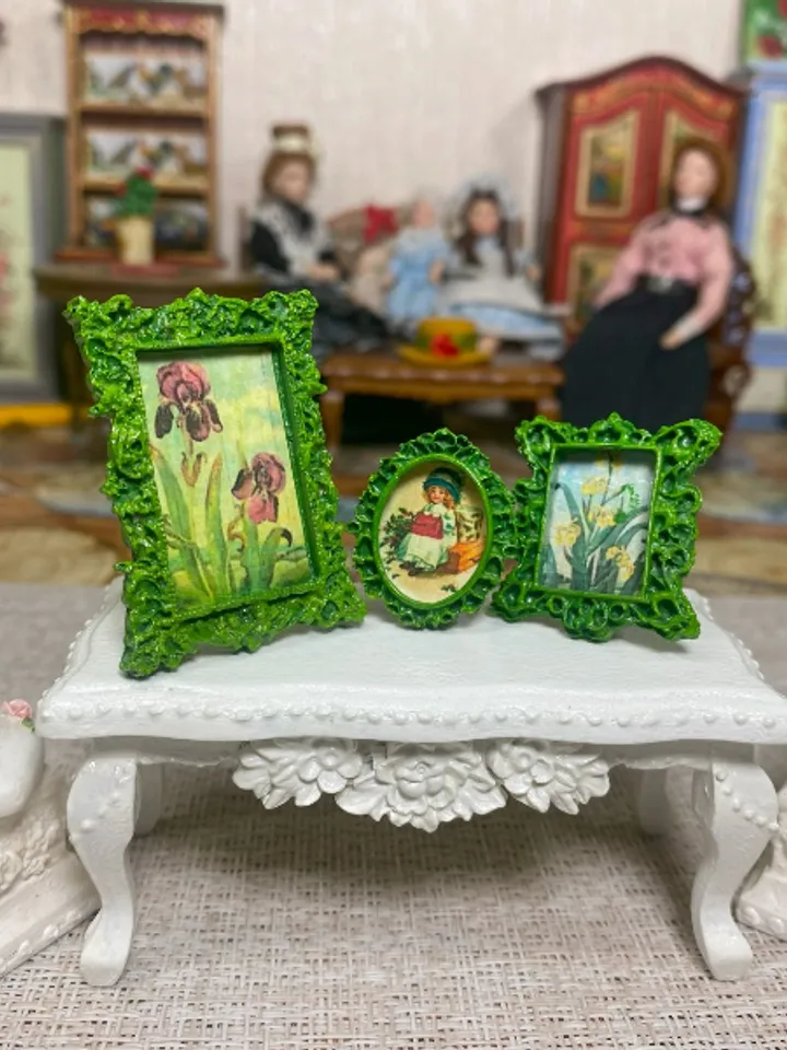 A set of frames with images of flowers. Dollhouse miniature. 1:12.
