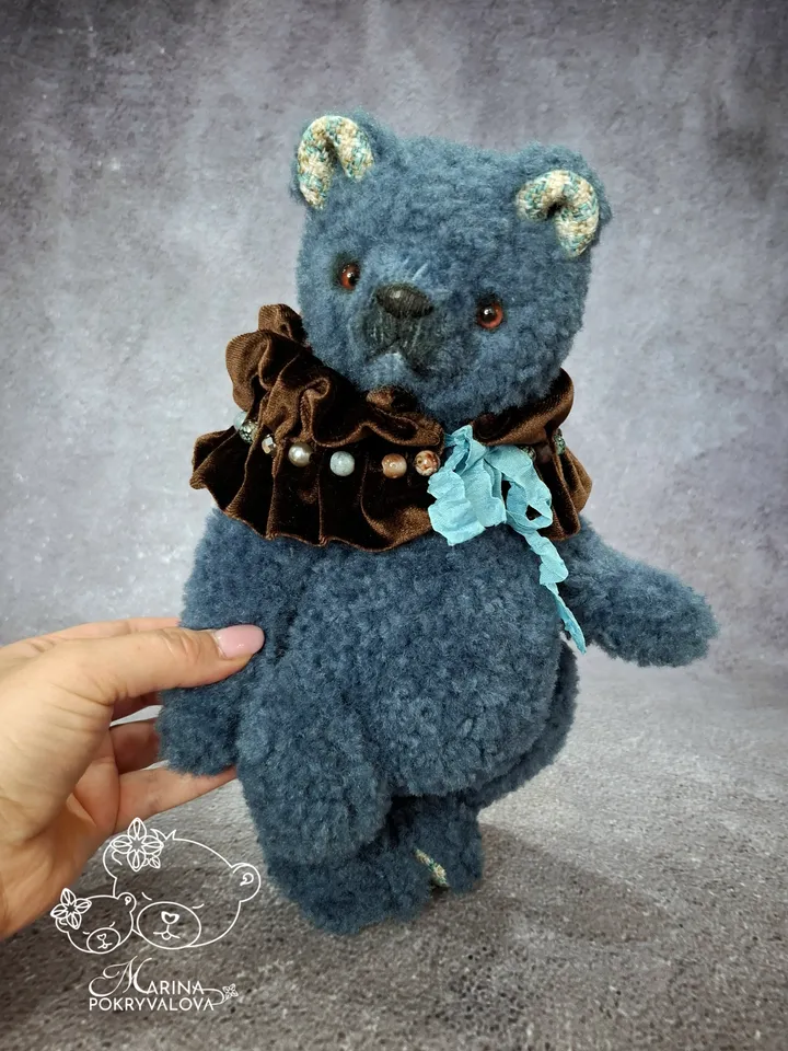 Blue teddy bear. Handmade toy. Plush bear.