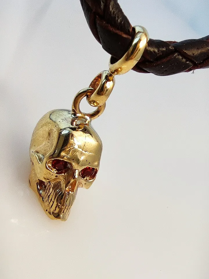 Skull pendant with inlaid natural garnets