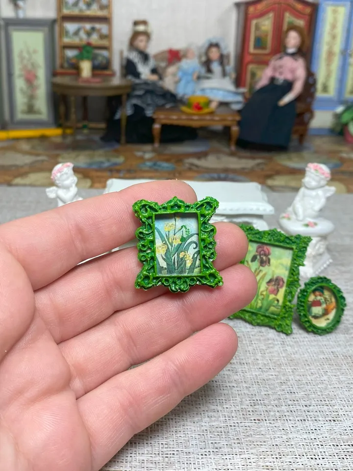 A set of frames with images of flowers. Dollhouse miniature. 1:12.