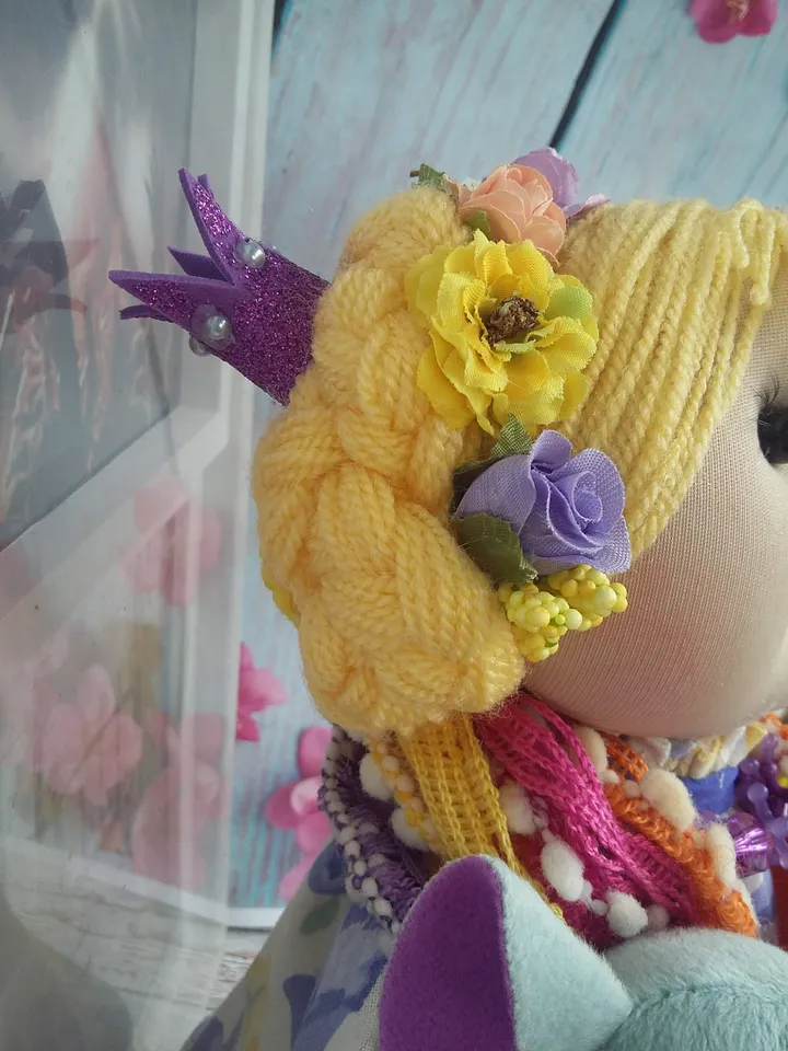 Doll Princess in the crown with an elephant in her hands, with yellow hair, beautiful, interior, birthday present, holiday