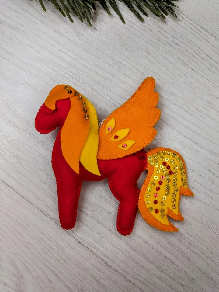 Pegasus in ancient Greek mythology is a winged horse, a favorite of the muses. Felt toy Red fiery Pegasus
