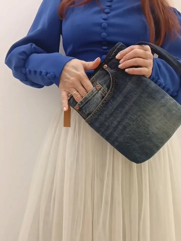 A small denim clutch bag , recycled jeans purse, closes with a zipper, 3 functional jeans pockets on the outside, cotton and 2 pockets on the inside.
